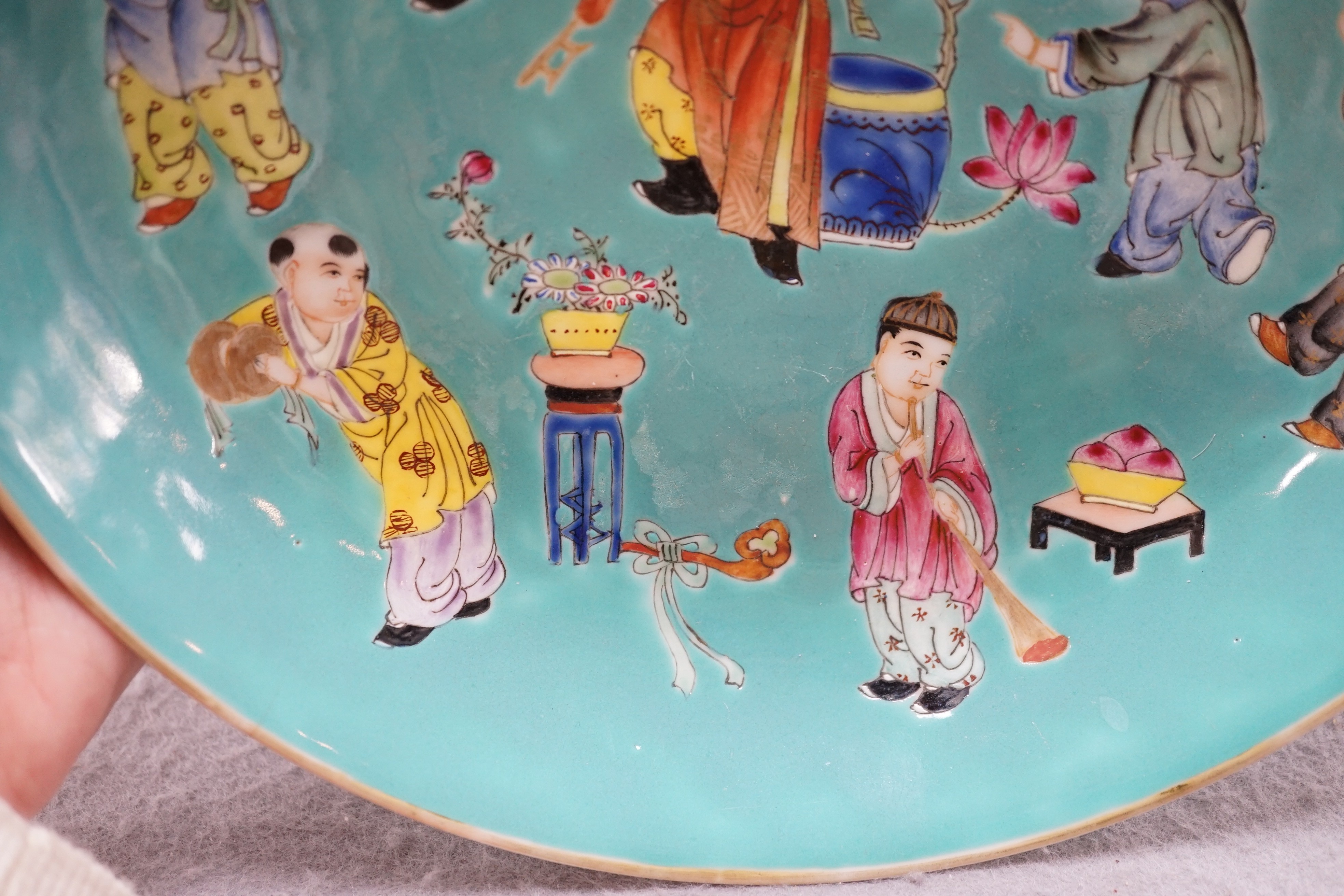 A Chinese turquoise ground 'Boys' dish, Jiaqing seal mark but Republic period, 23.5cm diameter, two hairline cracks